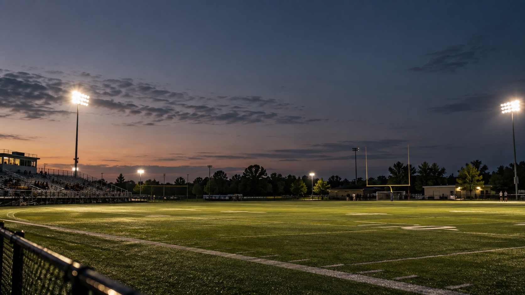 Evening youth sports field filled with families